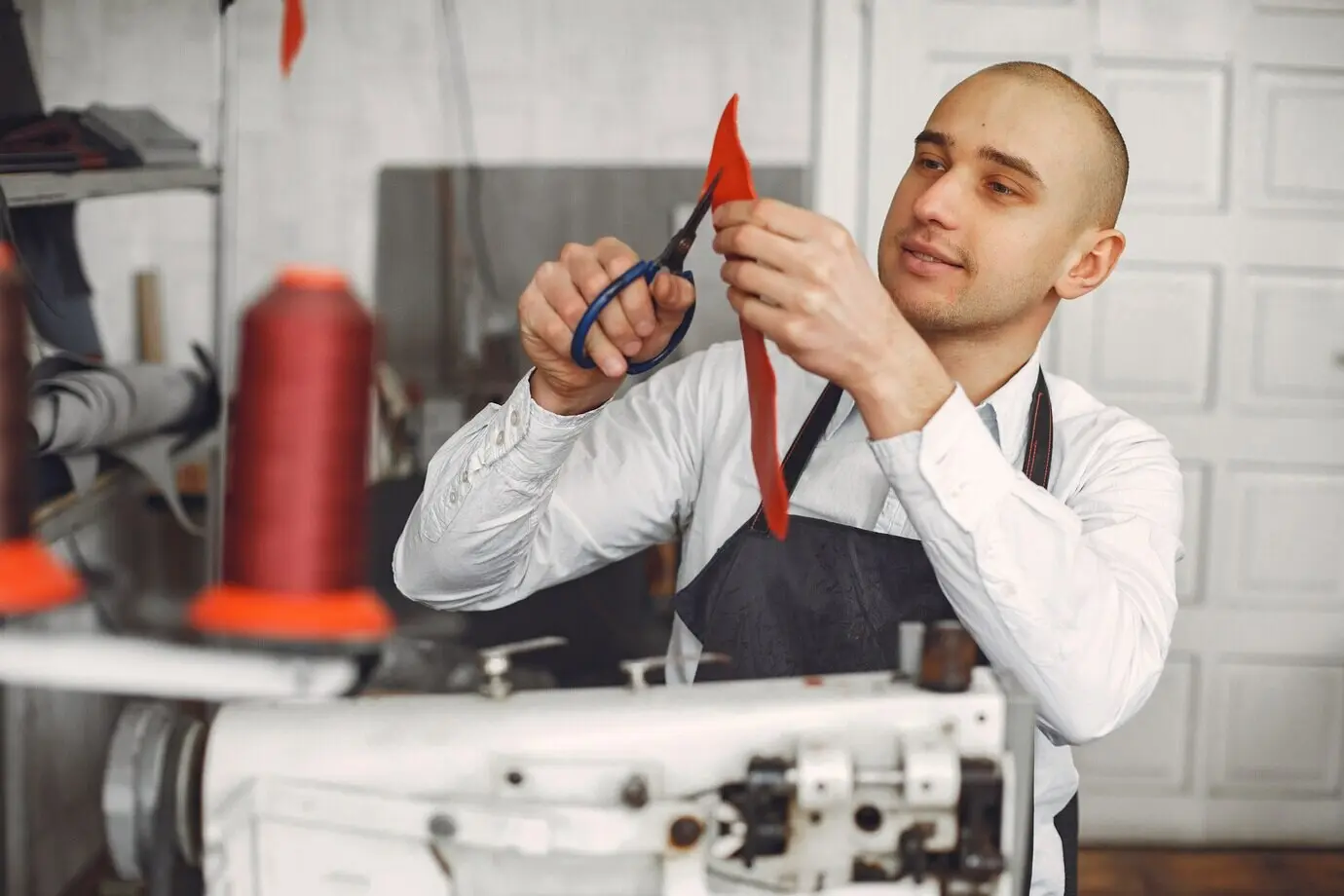 Ein Mann stellt Lederwaren her.