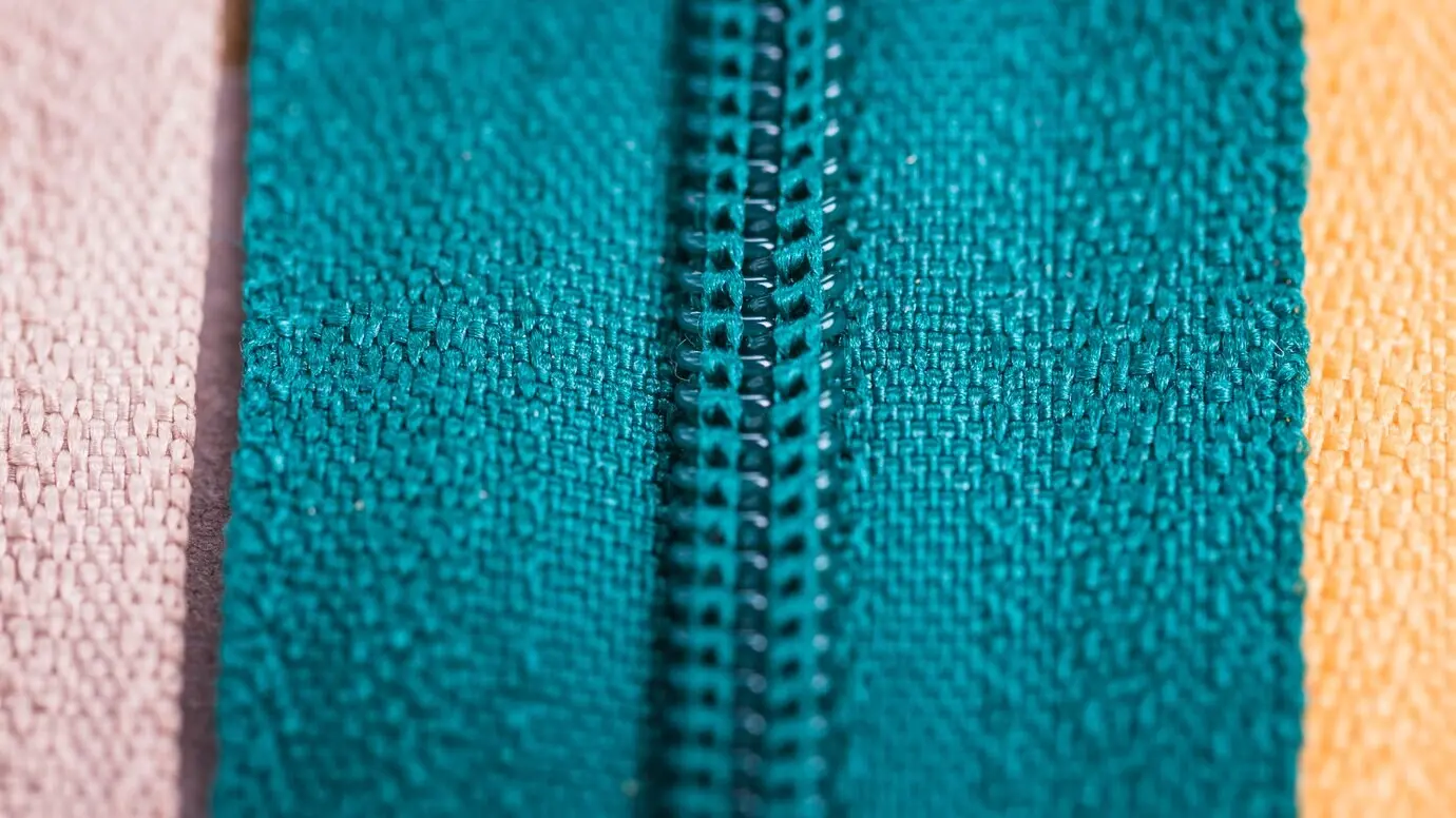 Drei verschiedene Reißverschlüsse in einer Reihe.